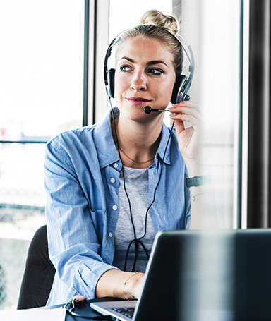 Sqre|Person at a computer wearing a headset