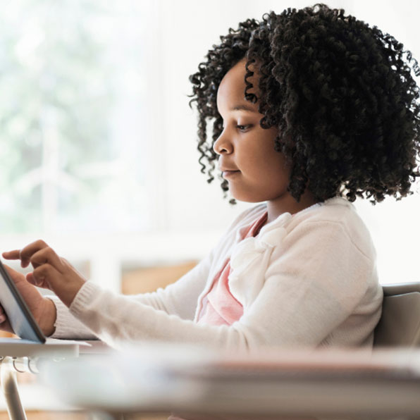 Sqre | Young student using a tablet in the classroom