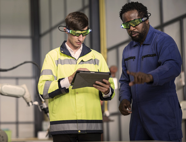 Sqre|Factory workers looking at a tablet