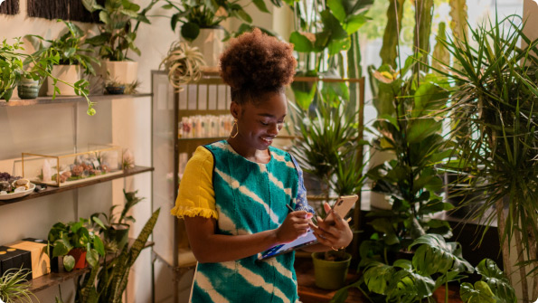 Wide|woman looking at smartphone home office