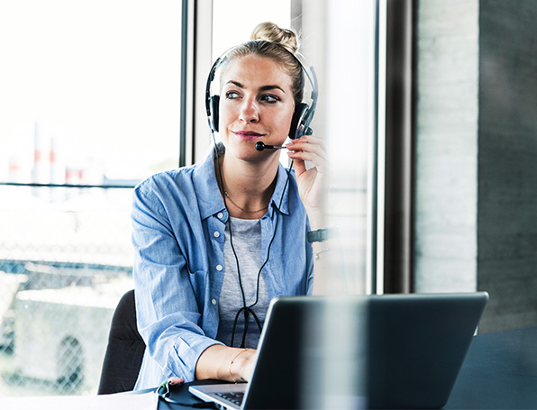 Sqre|Person at a computer wearing a headset