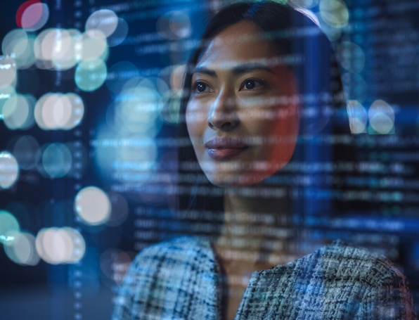 Sqre|Woman working on a lines of code projected on her face