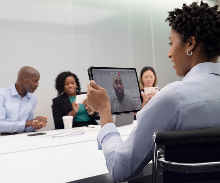 Tile|Employees at a video conference meeting