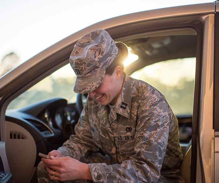 military-member-looking-at-phone-smiling.jpg