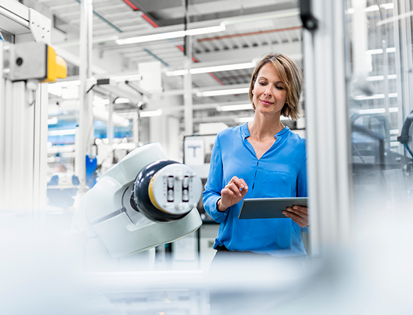 Sqre|Engineer woman in robotics facility on tablet