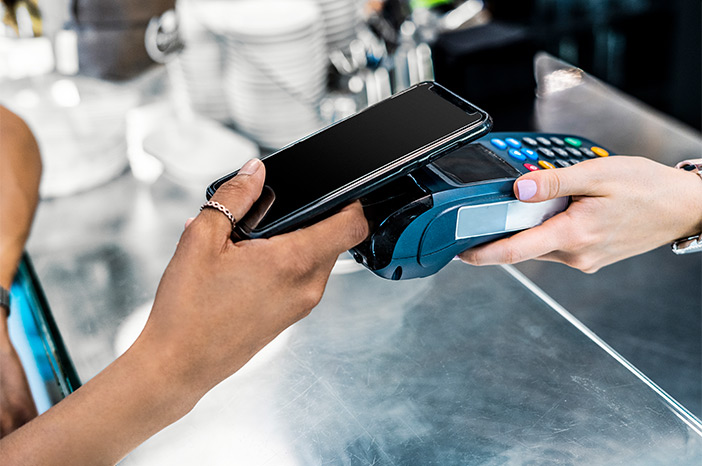 Tile|Consumer using a smartphone to pay on a handheld point-of-sale system