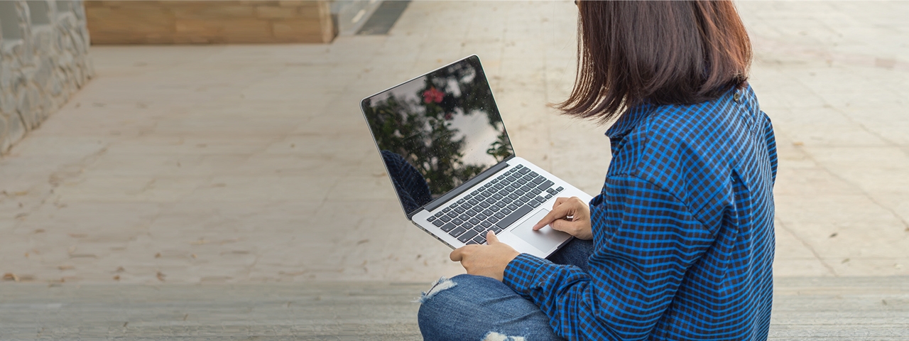 Tile|Close up of a student using a computer