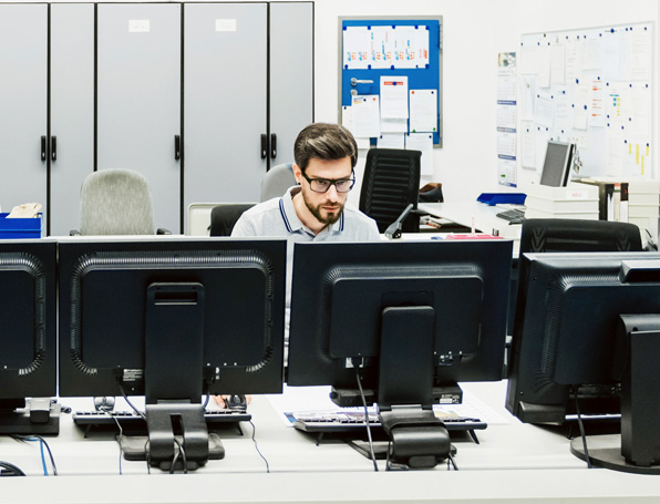 Sqre|Engineer sitting in control room, monitoring screens