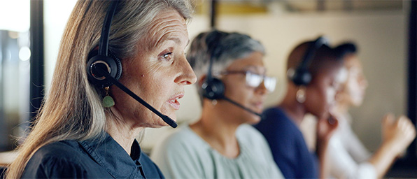 Full| Team of people wearing headsets in a call center