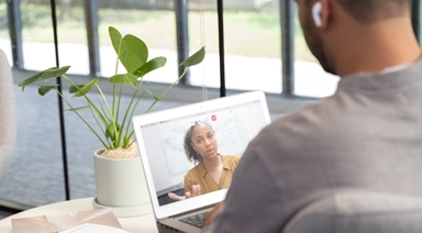 Wide|Person holding a conference call on a laptop