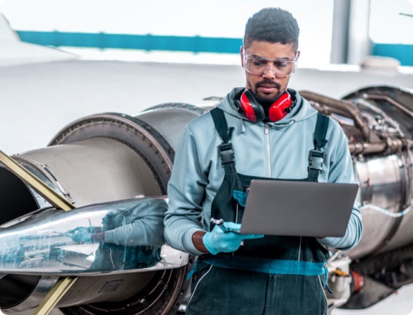 Tile|Military engineer looking at a laptop