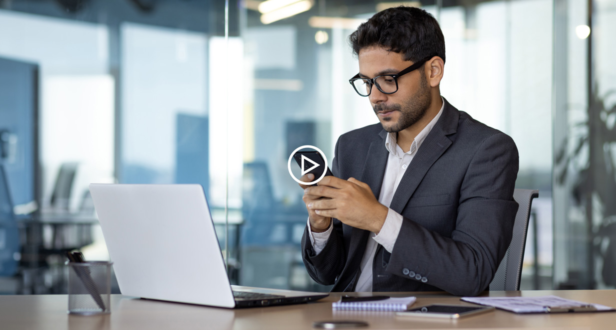 Serious thinking businessman using phone at workplace, arab boss in business suit thinking inside office reading online news using app on smartphone