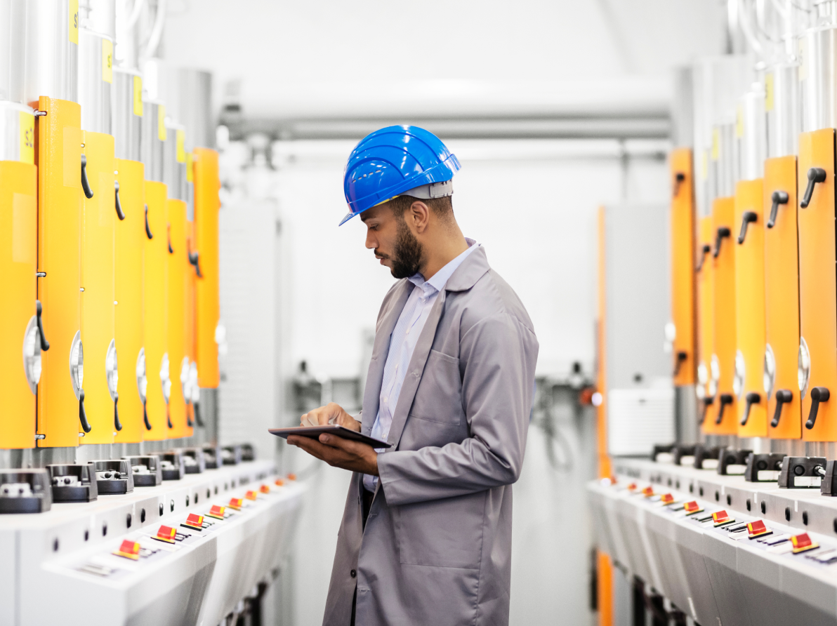 Man in manufacturing facility using tablet