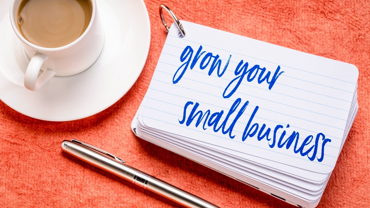 coffee cup on table, text reads grow your small business