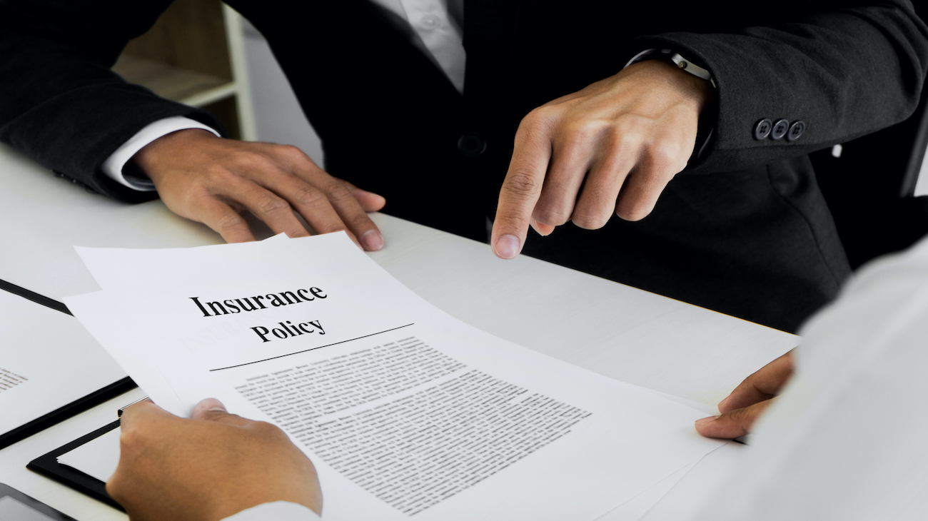 Insurance agent explain consulting with customer to signing the policy form.