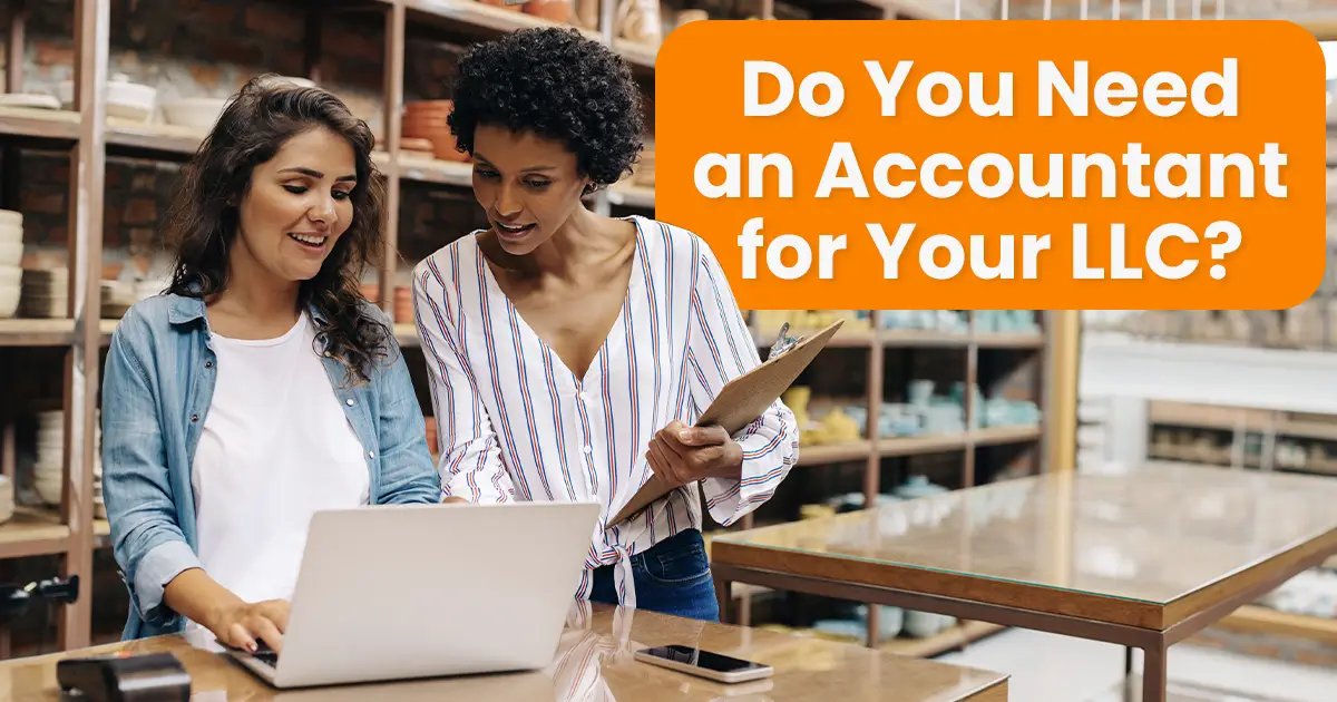 Two women are discussing something on a laptop. One holds a clipboard. Text in the image reads, "Do You Need an Accountant for Your LLC?" Shelves with items are visible in the background.