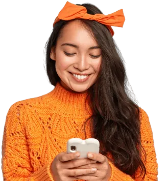 Mujer sonriendo mientras ve su celular