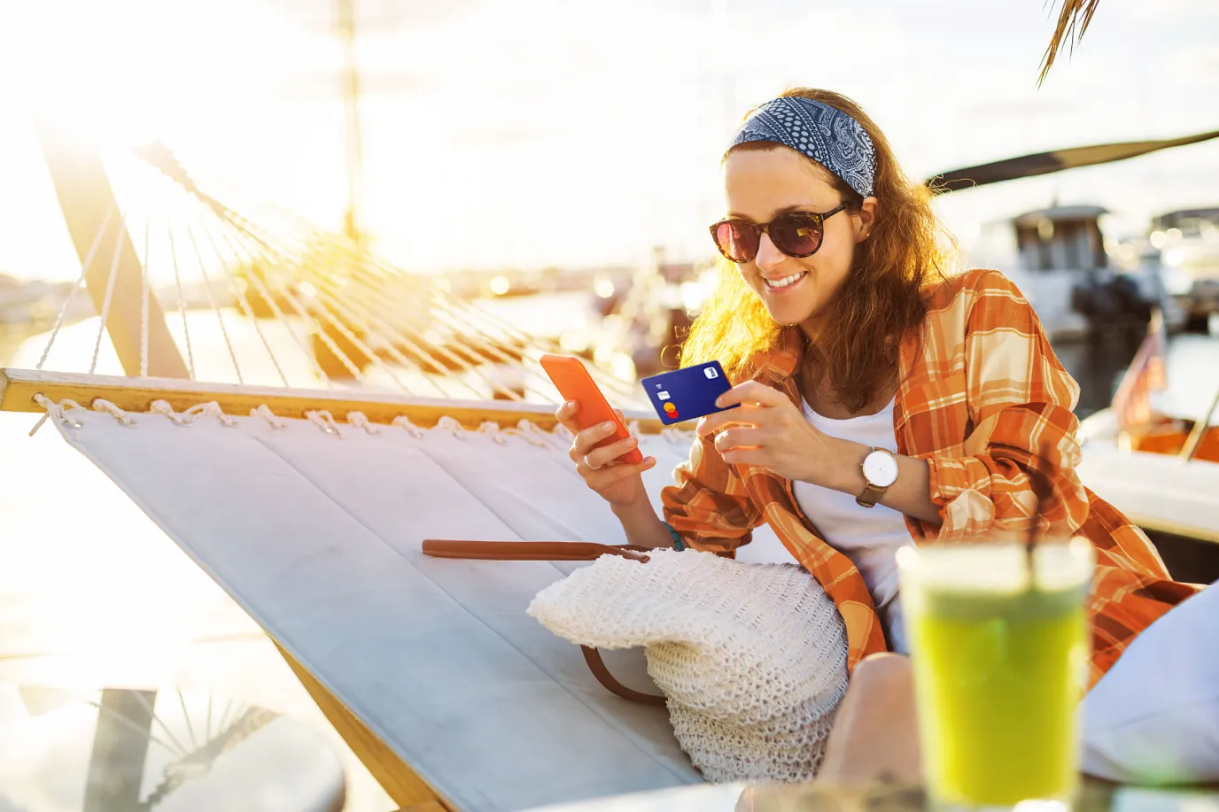 Mujer usando su celular y su tarjeta