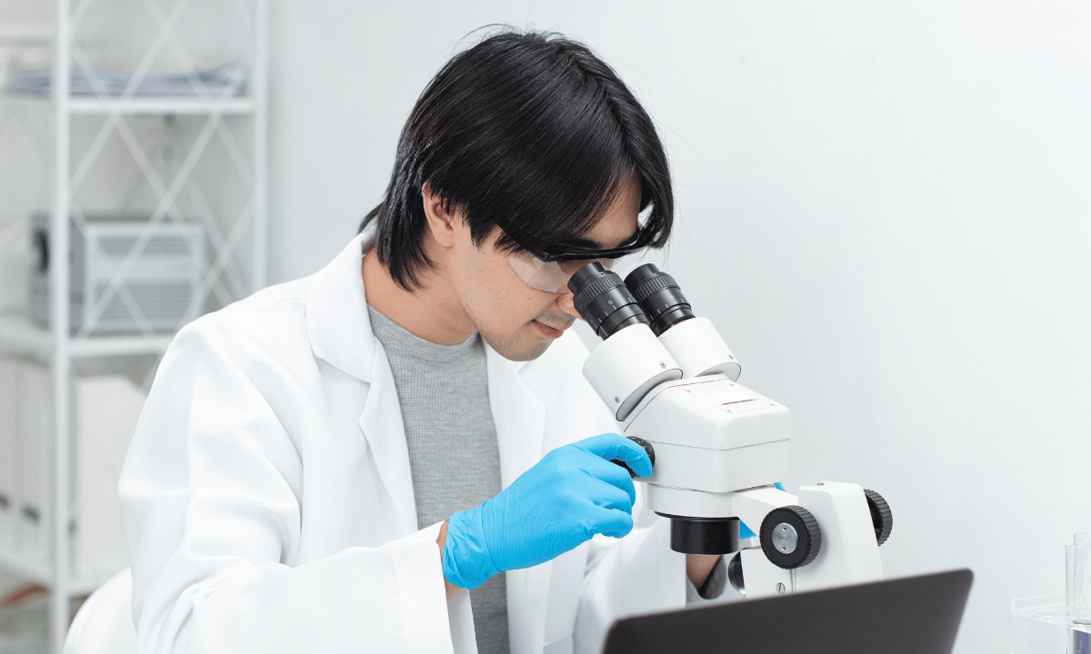 image of male doctor looking at microscope