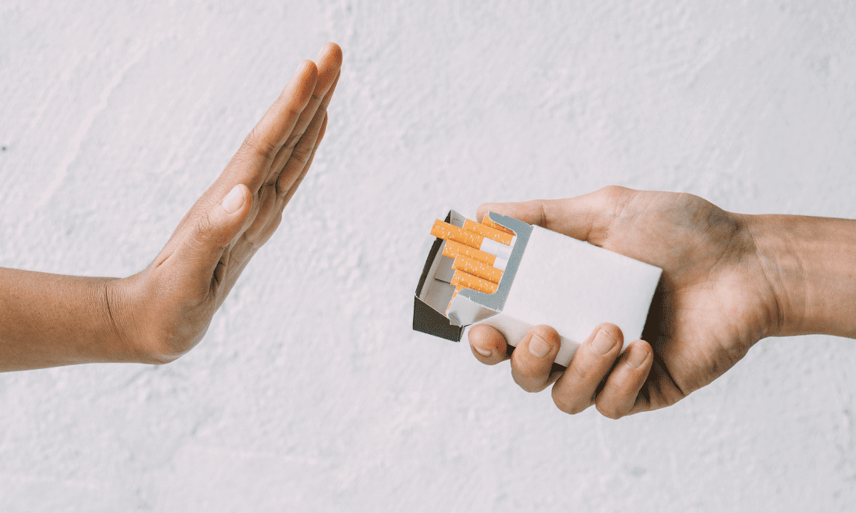 A hand declining a cigarette invitation