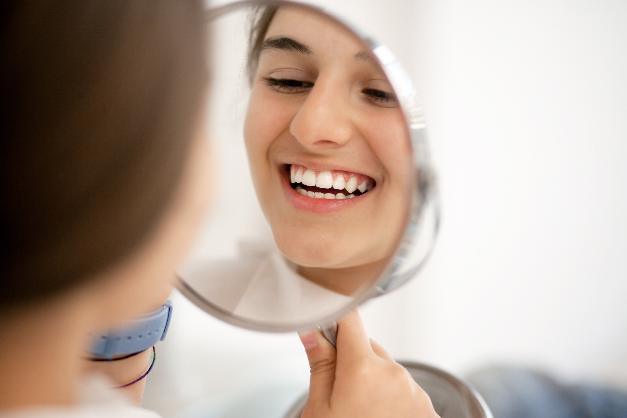 Woman-looking-at-her-teeth-in-the-mirror.jpg