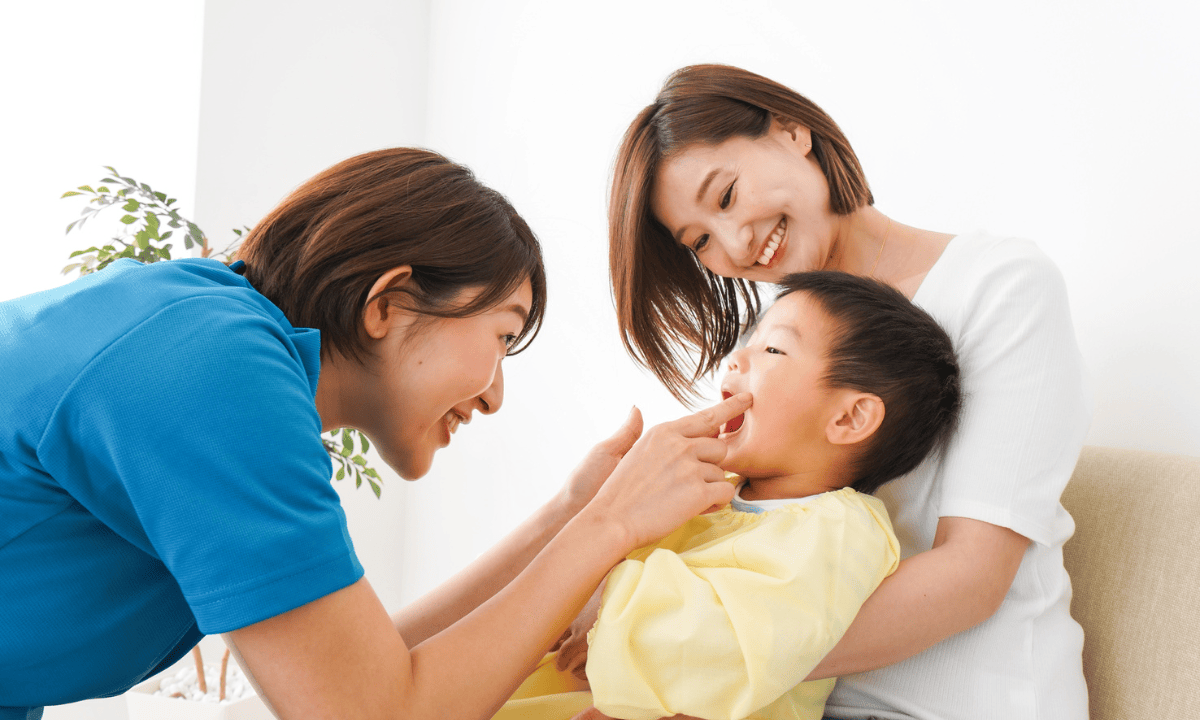 image of paediatric dentist checking a baby's mouthbaby-bottle-tooth-decay-complications.png