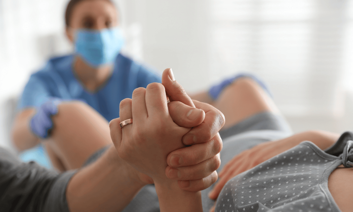 husband giving support to his wife during labour
