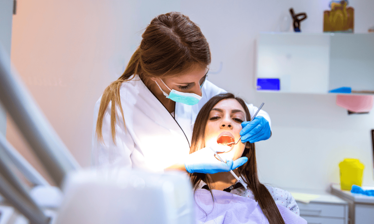 a dentist performing dental check-up 