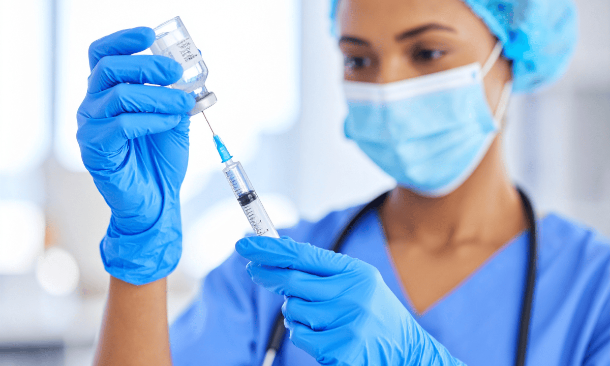 healthcare provider inserting syphilis treatment to syringe