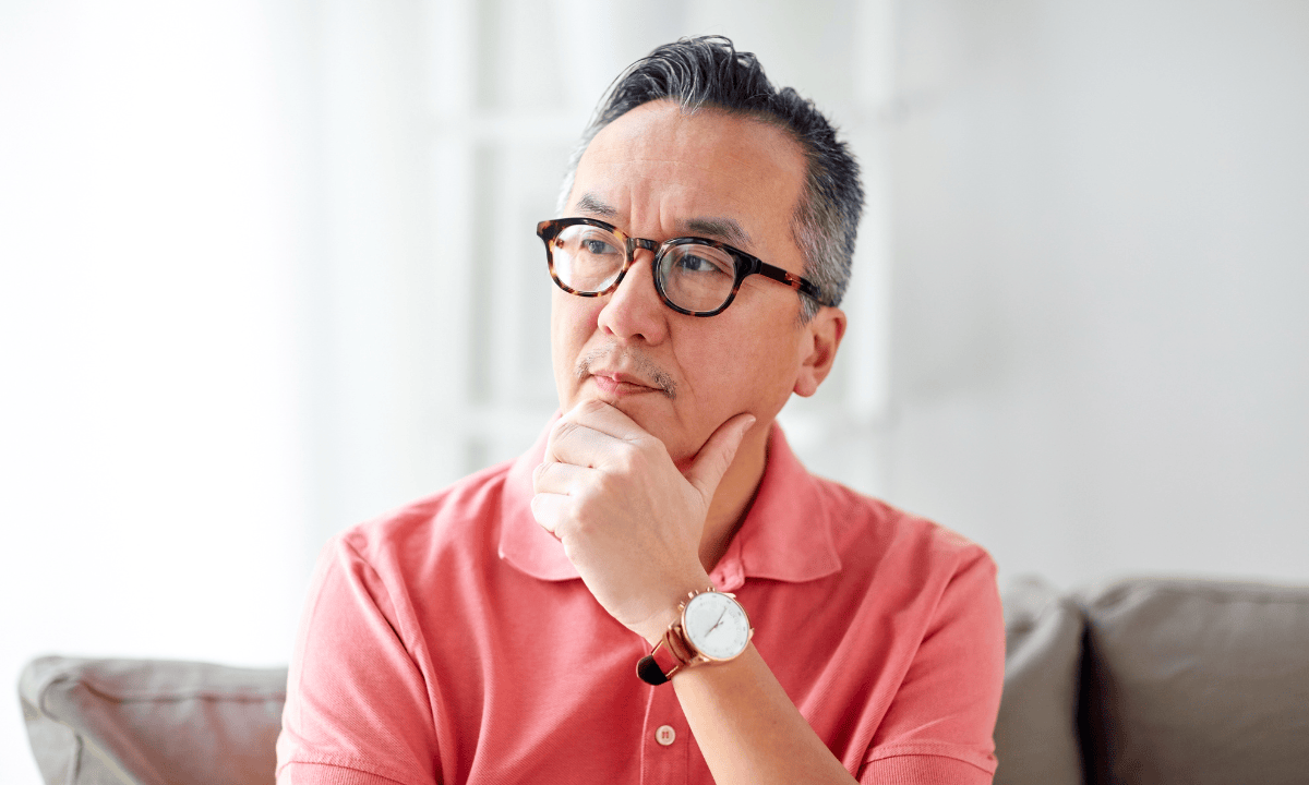 asian man considering health insurance