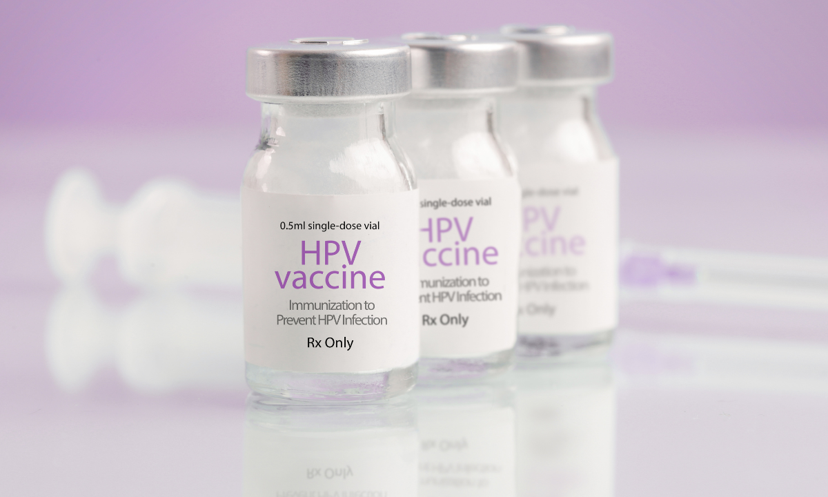 Three small glass vials of HPV (Human Papillomavirus) vaccine, labeled