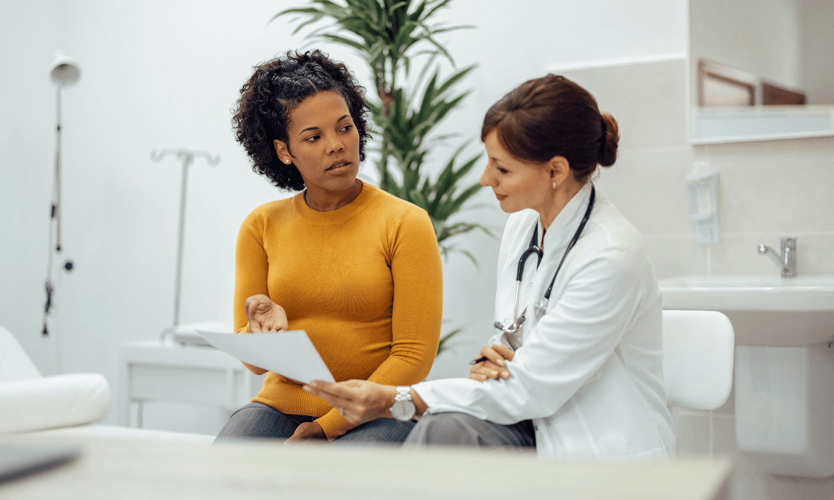 Mother consulting with doctor, consultation about her condition, doctor showing consultation results to her patient, doctor consultation