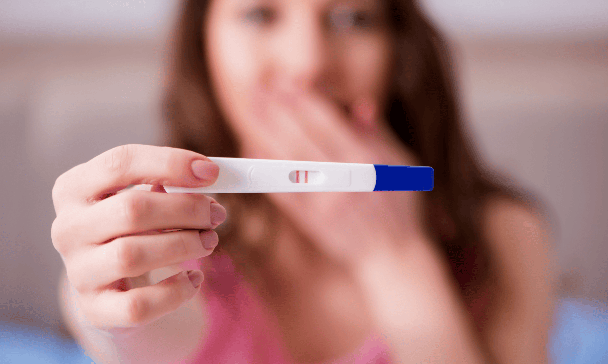 image of women surprised that her pregnancy test is positive