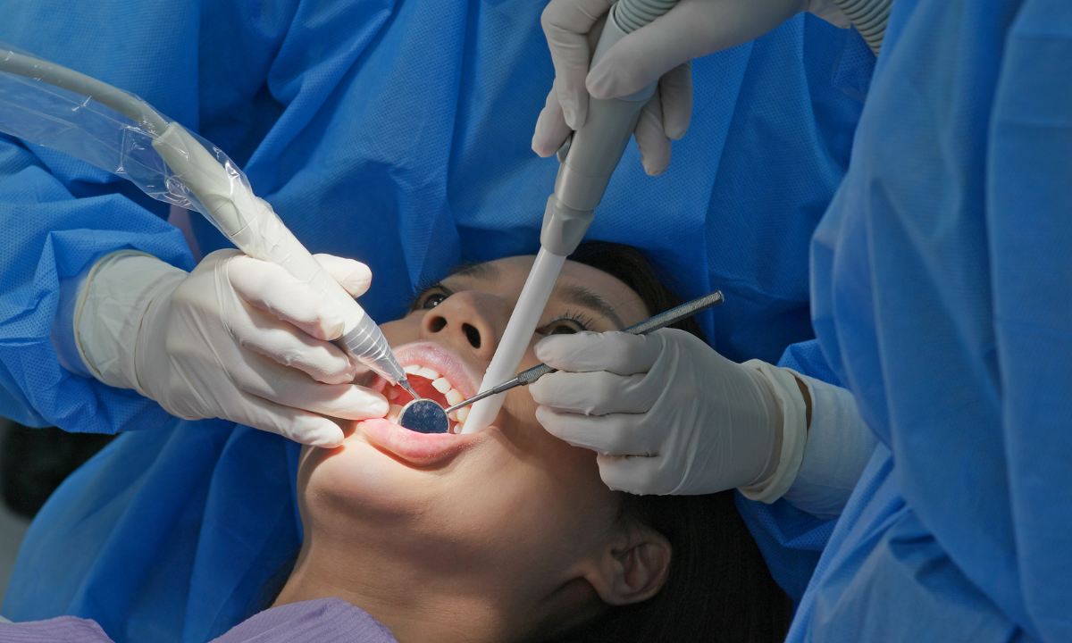 A female patient undergoing dental scaling