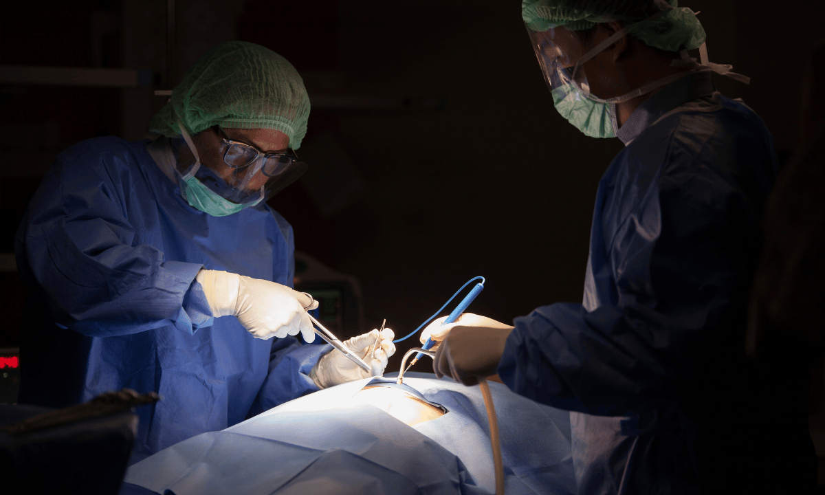 Surgical team operating on patient during medical procedure.