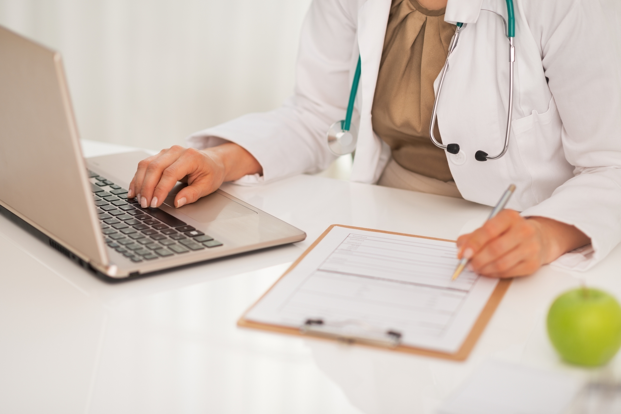 primary care doctor completing health screen report for patient