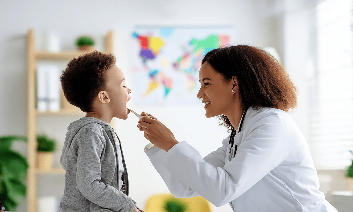 Image of a doctor examining child's temperature