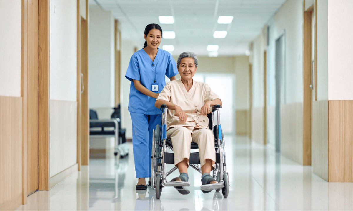 Image of a nurse guiding a patient on wheelchair