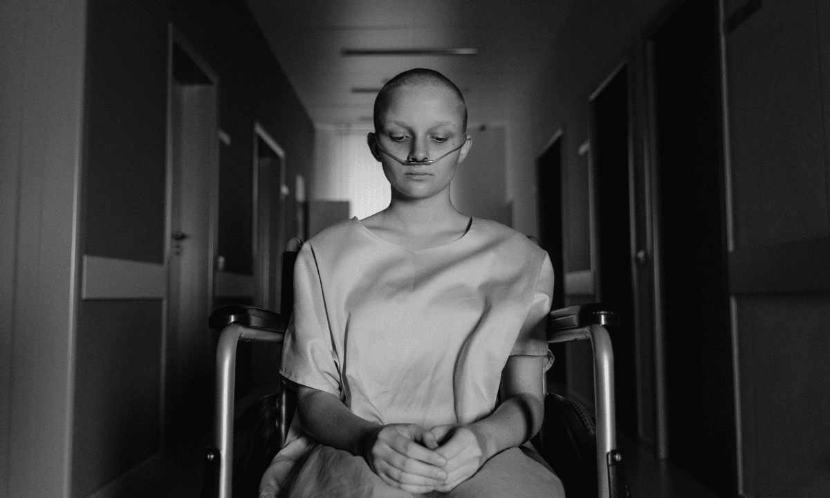 a bald woman in a wheelchair