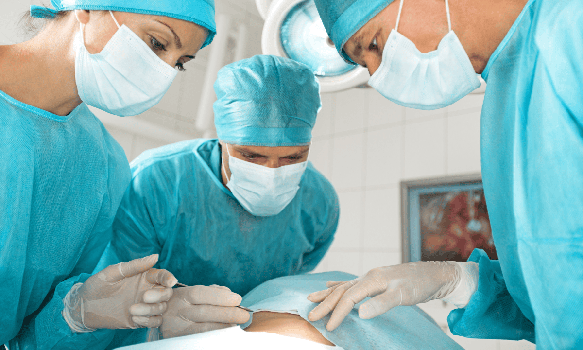 A surgeon team looking at a patient
