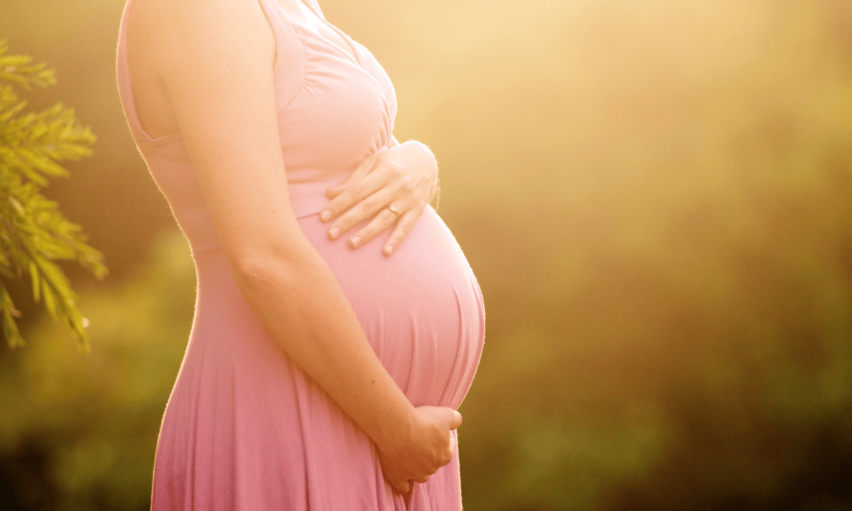 Image of a pregnant woman holding her stomach