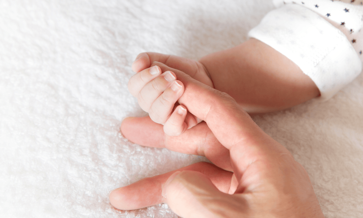 image of a baby's hand hold the mother's finger
