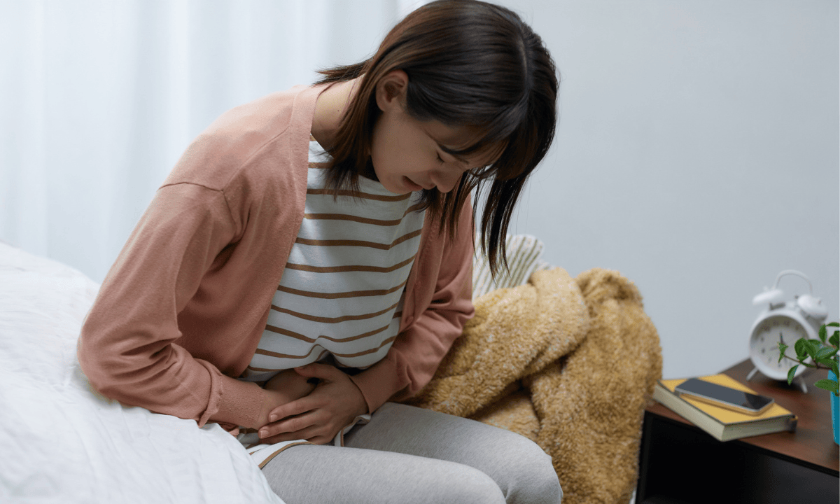Image of a woman holding her belly