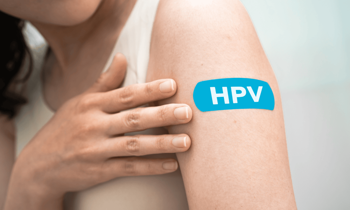HPV vaccine bandage on woman's arm