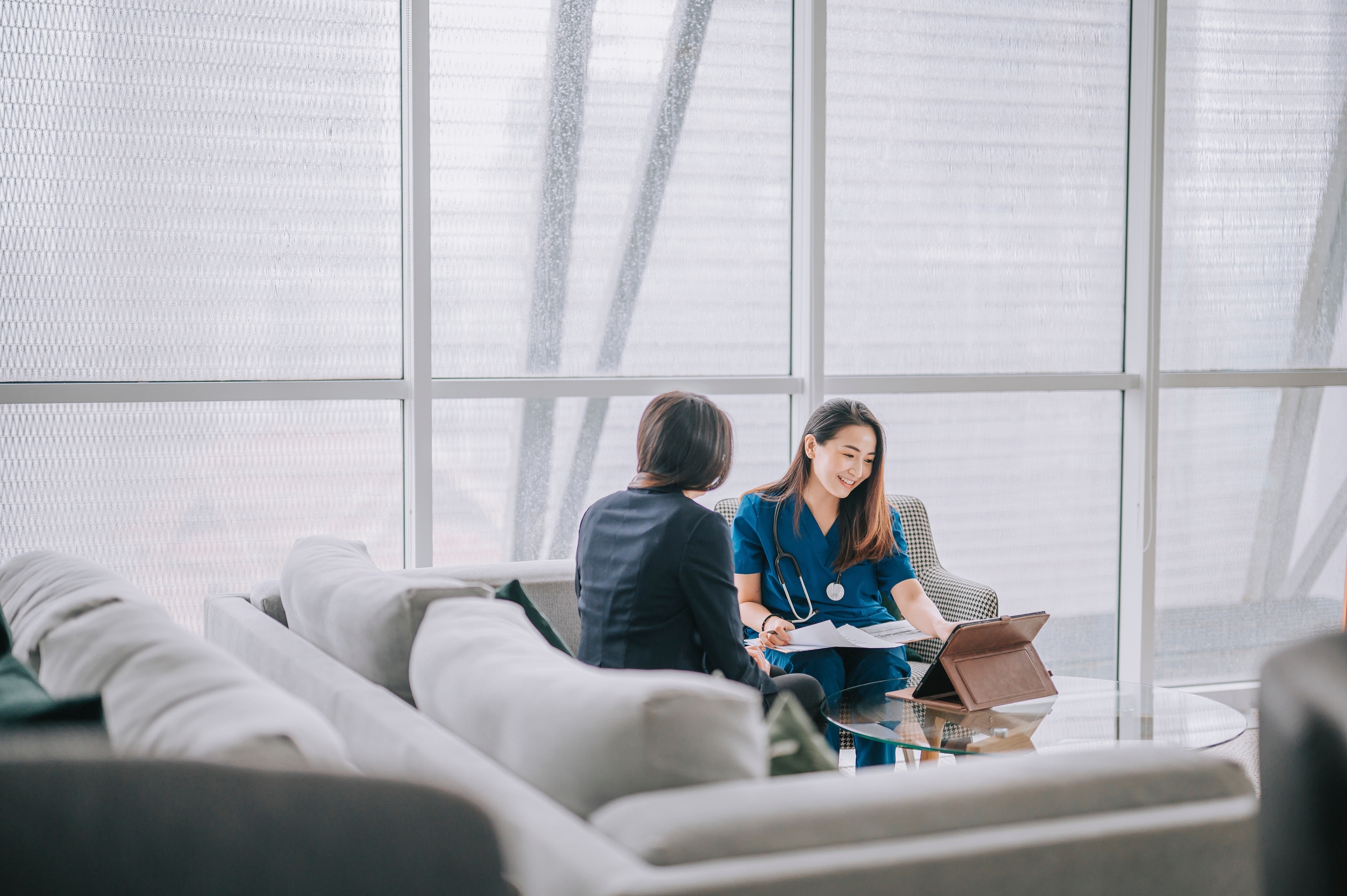 young asian doctor consulting female patient on health screening results