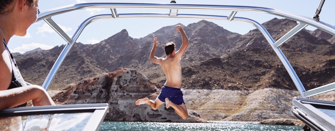 Man jumping off a boat