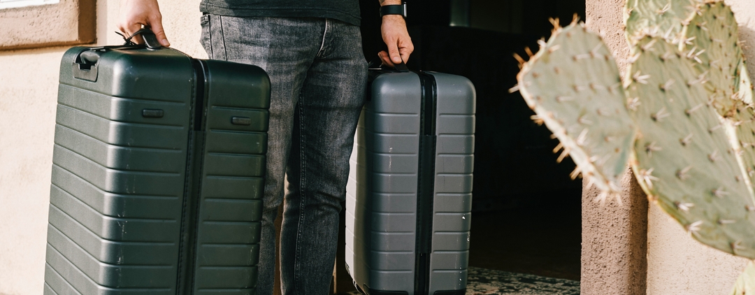 Man carrying two suitcases