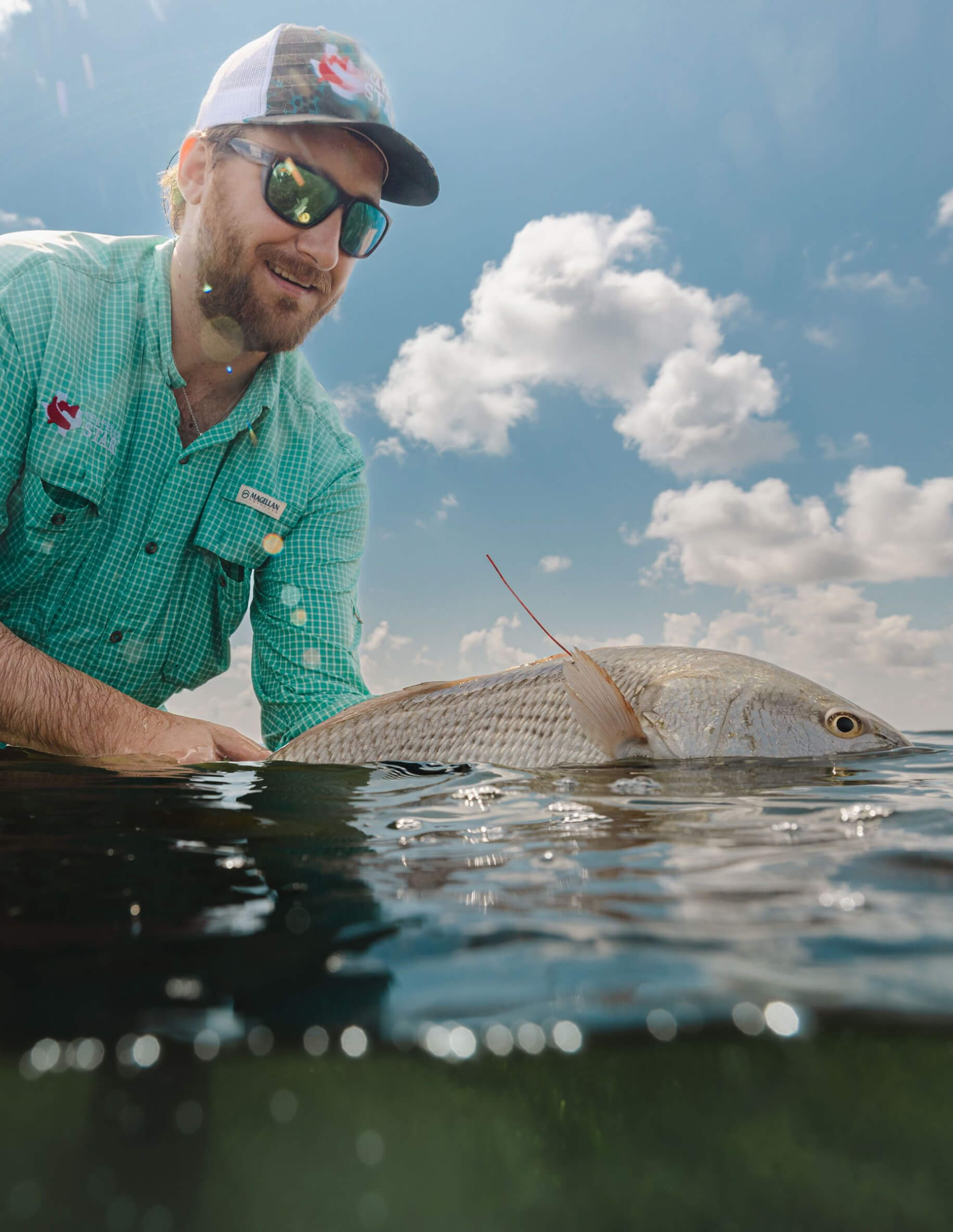 Man holding fish just above the water