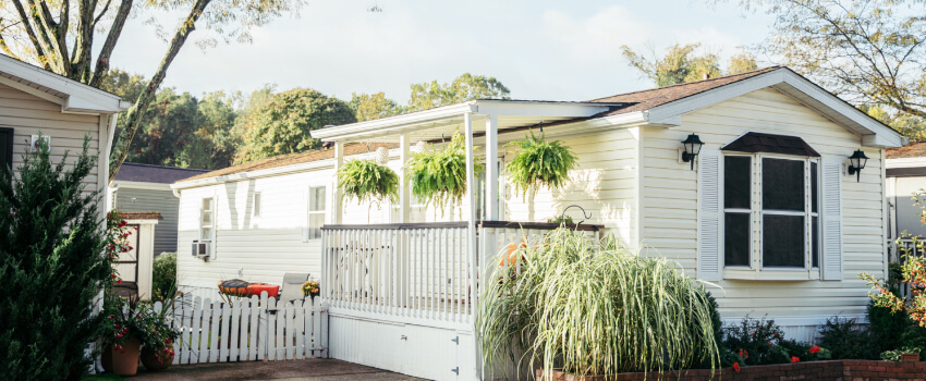 Outside view of yellow mobile home.