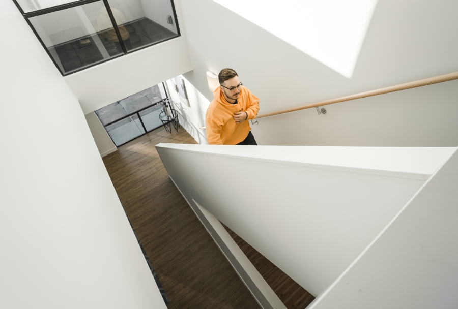 Person in yellow climbing up staircase